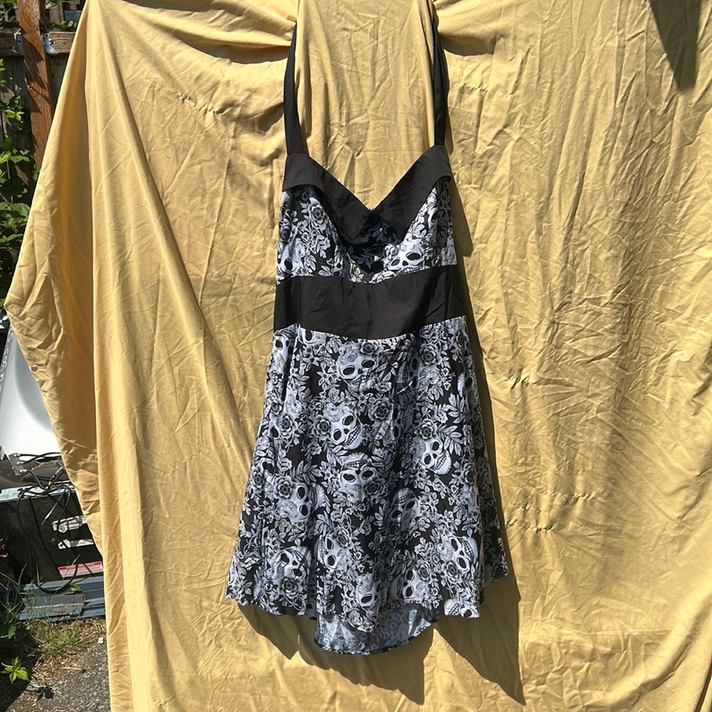 Adorable halter dress with skull/flower pattern. Zipper on side. Light material